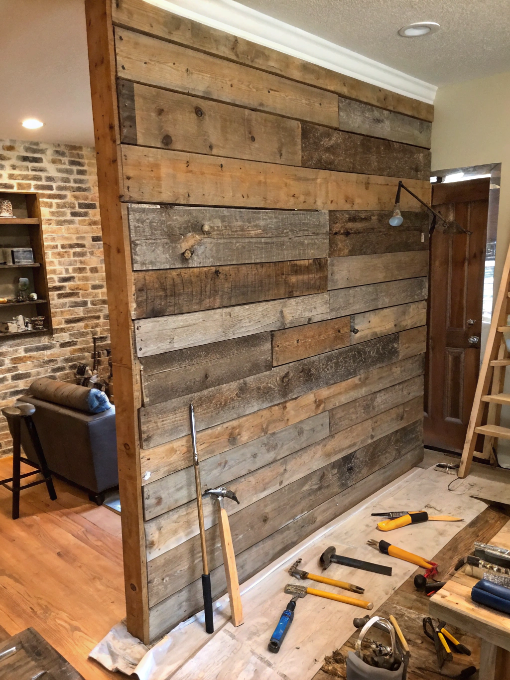 A person measuring and marking a wall for a DIY reclaimed wood accent wall project.