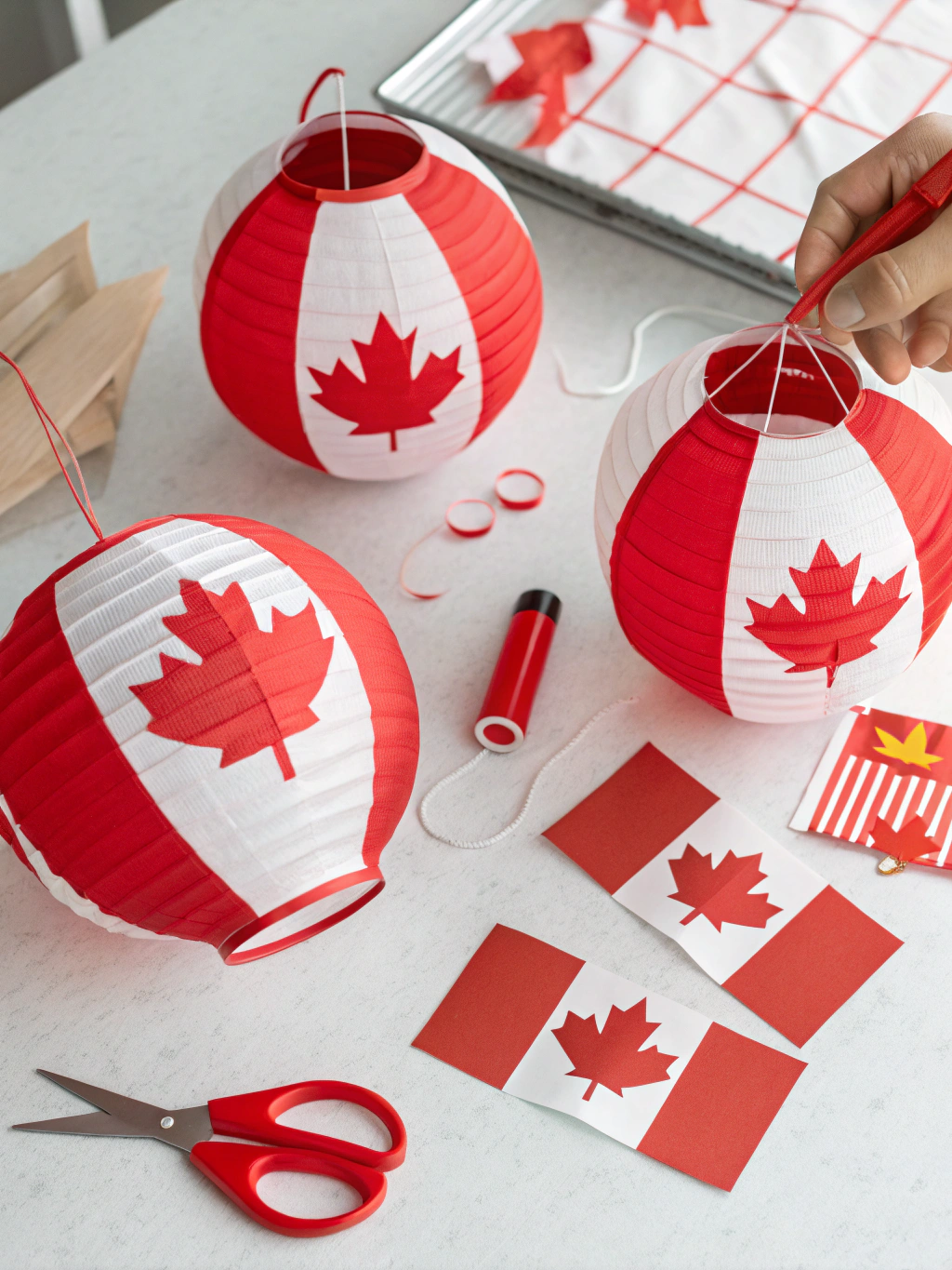 Step 2 of easy Canada Day crafts DIY Windsocks: Attaching red and white streamers to the paper ring.