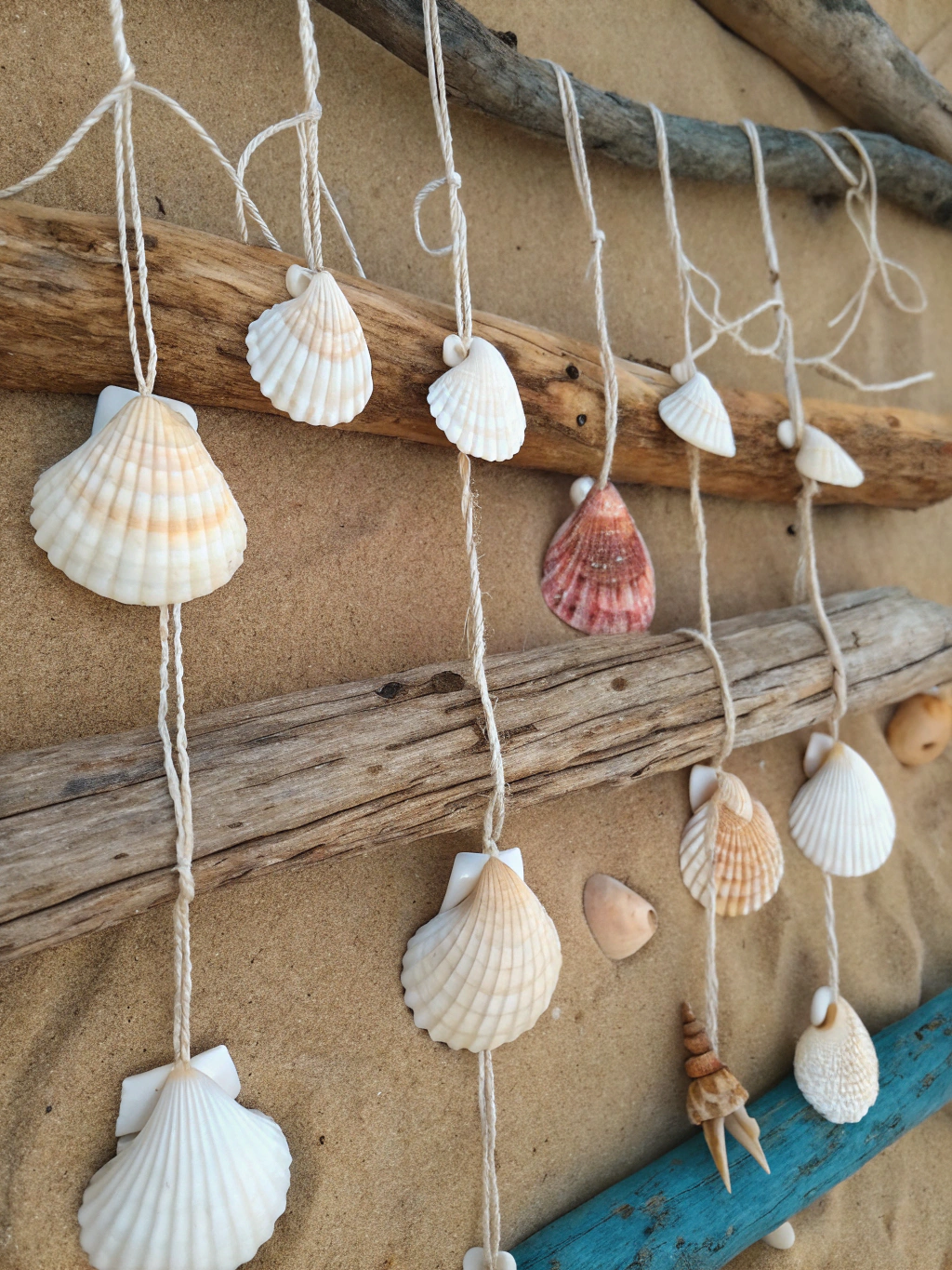 Materials and tools for DIY seashell wind chime project An assortment of materials for a diy seashell wind chime, including shells, driftwood, string, and tools, neatly arranged on a workspace.