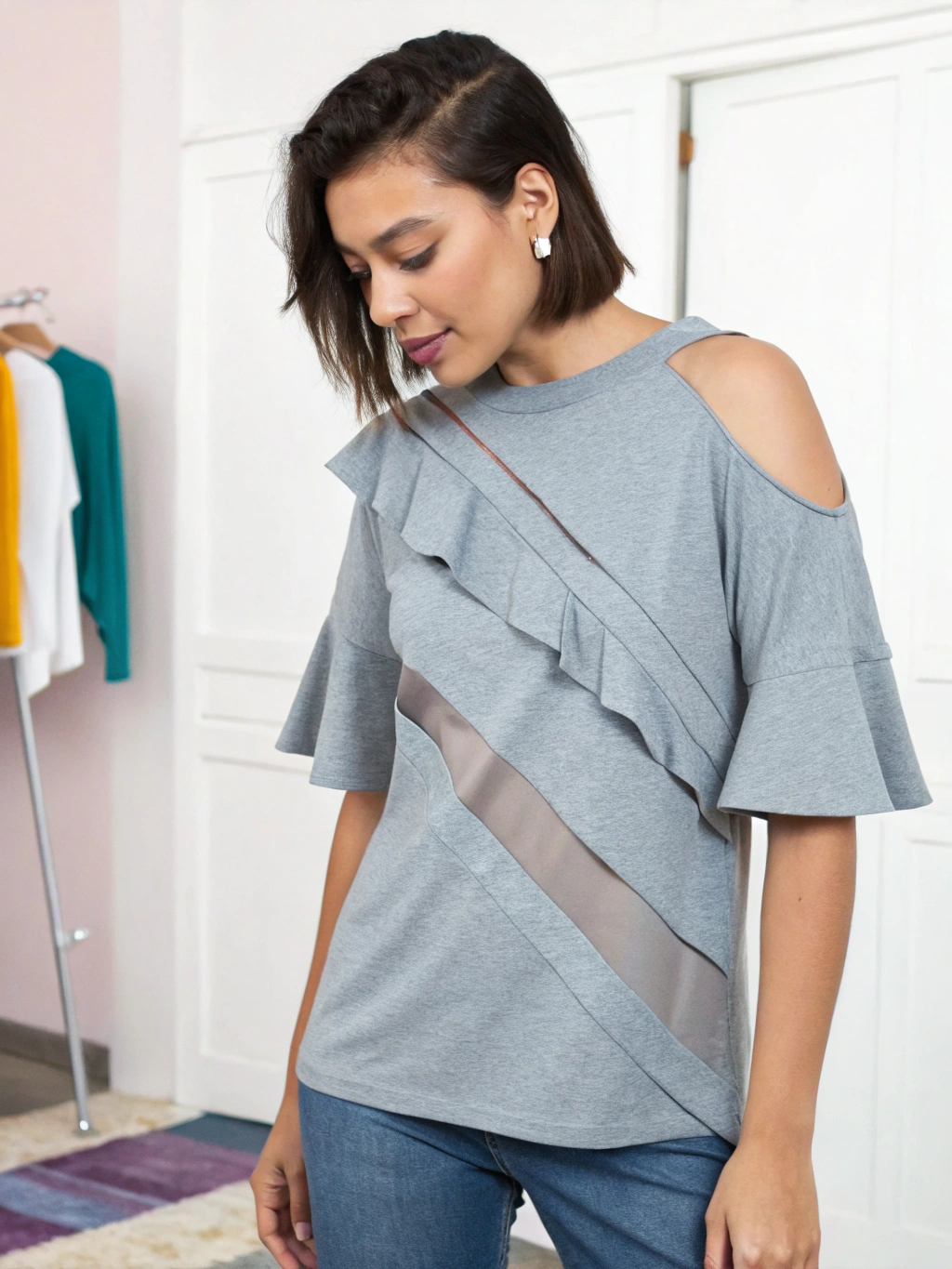 A person proudly wearing a creatively cut t-shirt, showcasing one of the DIY styles.